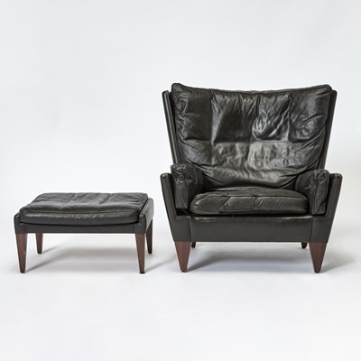Lot 203 - Illum Wikkelso Leather Upholstered Armchair and Ottoman