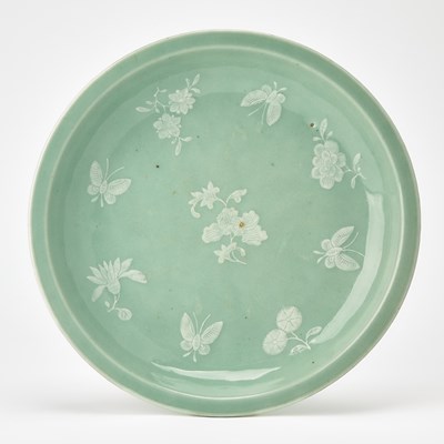 Lot 180 - A Chinese Slip-Decorated Celadon Glazed Porcelain Footed Dish