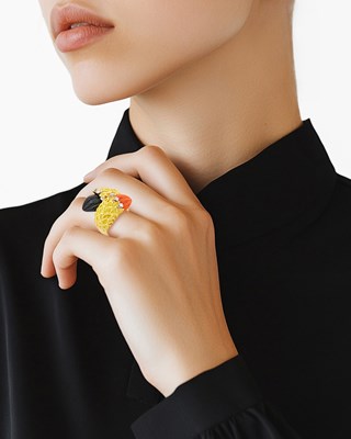 Lot 13 - Gold, Carved Black Onyx and Coral and Diamond Crossover Ring