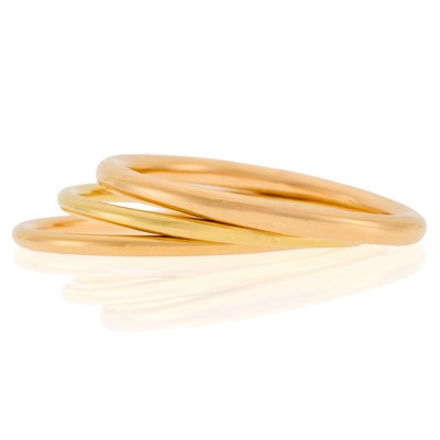 Lot 2006 - Gold Bangle Bracelet and Tiffany & Co. Two Gold and Rose Gold Bangle Bracelets