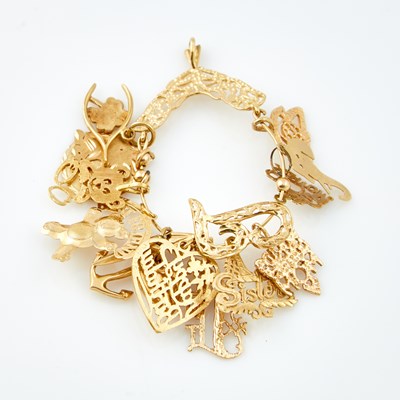 Lot 486 - Gold Charm Holder with 14 charms, 14K 9 dwt.