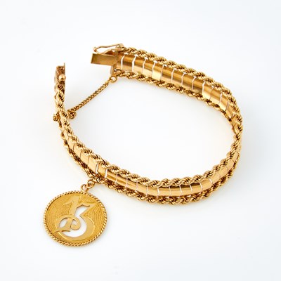 Lot 606 - Gold Flexible Bracelet with charm attached, 14K 21 dwt.