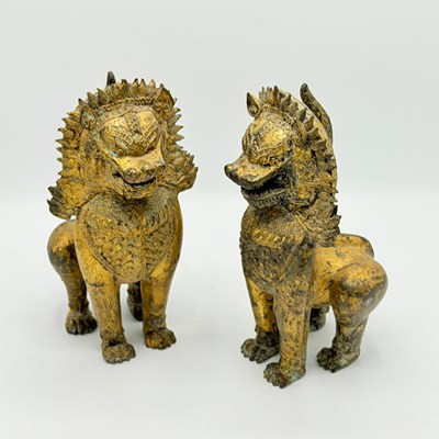 Lot 1184 - Pair of Thai Gilt-Cast Metal Lions
