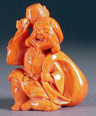 Lot 82 - Good Coral Okimono of Daikoku The jolly figure...