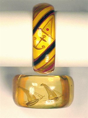 Lot 295 - Two Bakelite Reverse Carved Bracelets One...