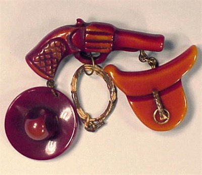Lot 417 - Bakelite Brooch Depicting a pistol suspending...
