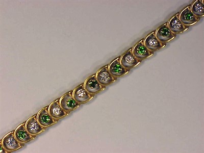 Lot 255 - Gold, Garnet and Diamond Bracelet 14 kt....
