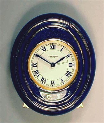 Lot 371 - Metal Table Clock Of oval outline and with a...