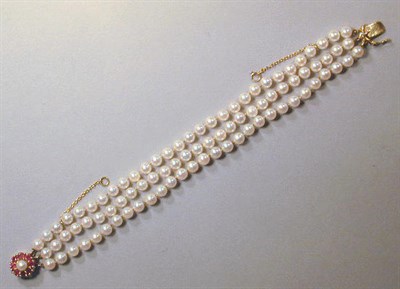 Lot 91 - Cultured Pearl and Ruby Bracelet The triple...