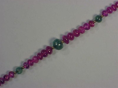 Lot 404 - Ruby and Emerald Bead Necklace The single...