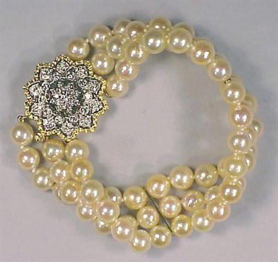Lot 199 - Cultured Pearl and Diamond Bracelet The triple...