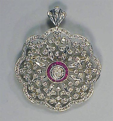 Lot 291 - Ruby and Diamond Flower Pin Pendant 18 kt....