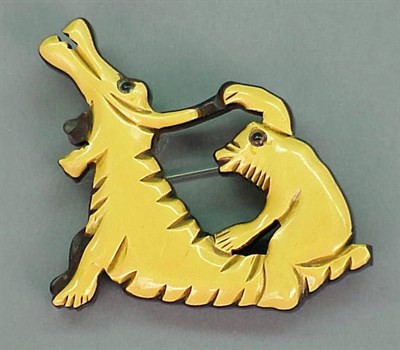 Lot 437 - Bakelite and Wood Brooch Depicting two...