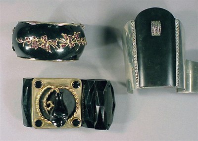 Lot 136 - Three Black Bracelets 1920s One enamel hinged...