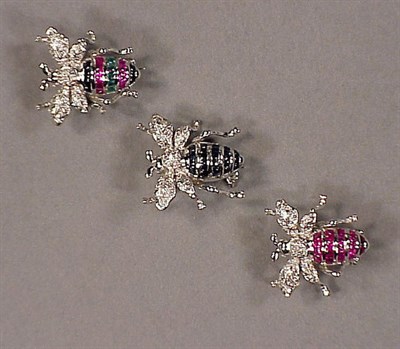 Lot 493 - Three Diamond and Colored Stone Pins 14 kt....