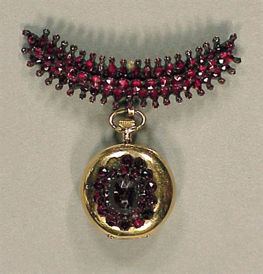 Lot 17 - Gold and Garnet Lapel Watch 14 kt. yellow gold,...