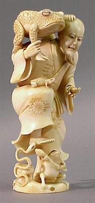 Lot 99 - Ivory Okimono of Man with Frogs Meiji Period...