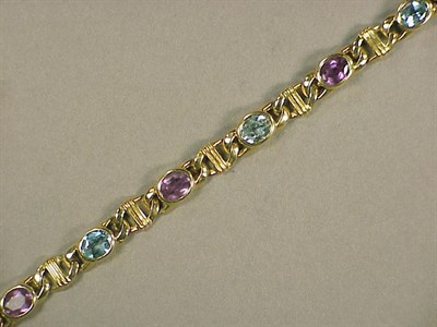Lot 186 - Gold, Amethyst and Blue Topaz Necklace 14 kt....