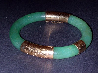 Lot 172 - Jade Bangle Bracelet The hinged band with 14...