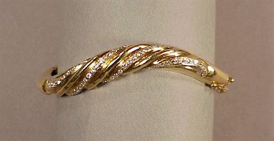 Lot 206 - Gold and Diamond Bangle Bracelet 14 kt. yellow...