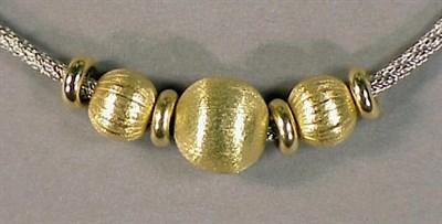 Lot 1 - Gold and Silver Necklace The silver cord...