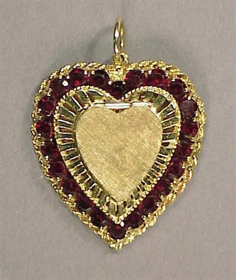 Lot 64 - Gold and Garnet Locket Pendant 14 kt. yellow...