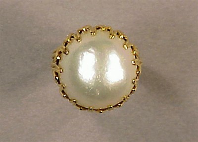 Lot 85 - Gold and Mabe Pearl Ring The 18 kt. yellow...