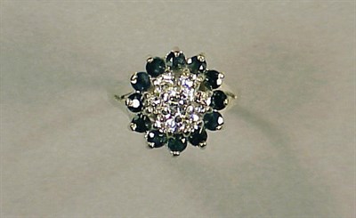 Lot 119 - Sapphire and Diamond Cluster Ring 14 kt. white...