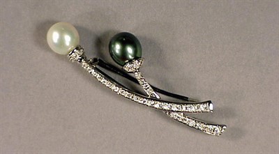 Lot 516 - Cultured Pearl and Diamond Brooch 18 kt. white...