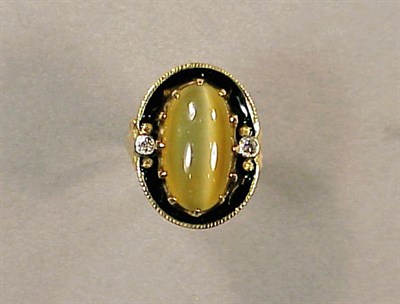 Lot 48 - Cat's-Eye Quartz and Diamond Ring 14 kt....