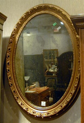 Lot 653 - Pair of Victorian Gilt-Decorated Oval Mirrors