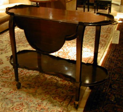 Lot 557 - Georgian Style Mahogany Rolling Cart The oval...