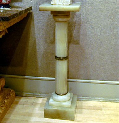 Lot 471 - White Onyx Pedestal The simple columnar...