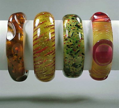 Lot 652 - Group of Four Bakelite Bracelets Each...