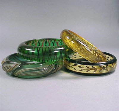 Lot 648 - Group of Four Bakelite Bracelets Each...