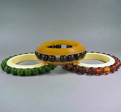 Lot 570 - Group of Three Bakelite Bracelets Each mounted...