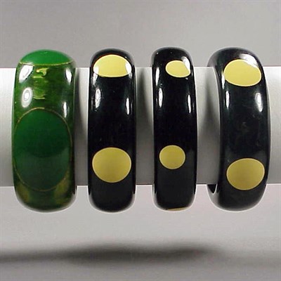 Lot 561 - Group of Four Bakelite Dot Bracelets Each in...