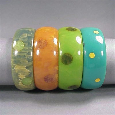Lot 641 - Group of Four Bakelite Dot Bracelets Each in...