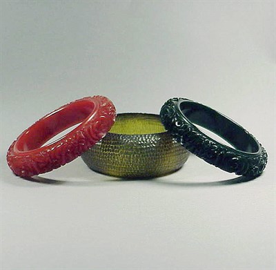 Lot 565 - Pair of Bakelite Bracelets Each with carved...