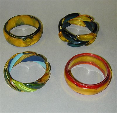 Lot 329 - Group of Four Bakelite Bracelets Each...