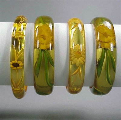 Lot 653 - Group of Four Bakelite Reverse Carved and...