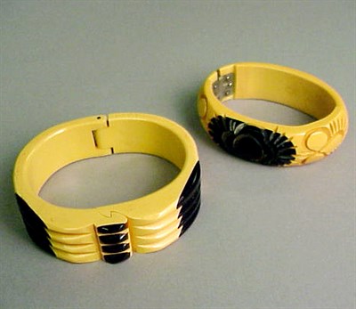 Lot 399 - Two Bakelite Two-Tone Laminat Hinged Bracelets...