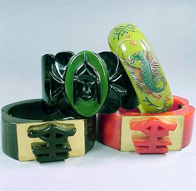 Lot 493 - Group of Four Bakelite Hinged Bracelets Each...