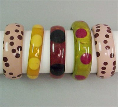 Lot 655 - Group of Five Bakelite Dot Bracelets Each in...