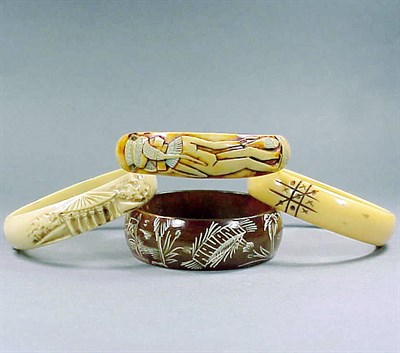 Lot 656 - Group of Four Bakelite and Celluloid Bracelets...