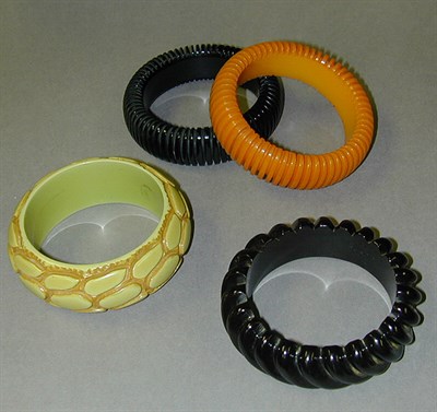 Lot 586 - Group of Four Bakelite Bracelets Each with...