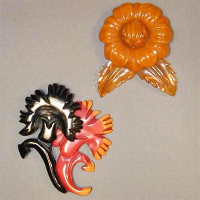 Lot 441 - Two Bakelite Brooches Each with carved floral...