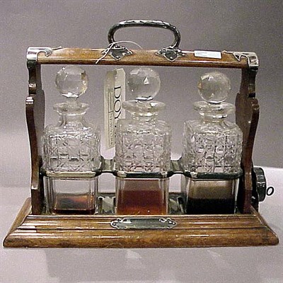 Lot 256 - Oak and Silver Plated Tantalus Set