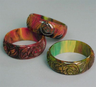 Lot 313 - Group of Three Bakelite End of Day Bracelets...