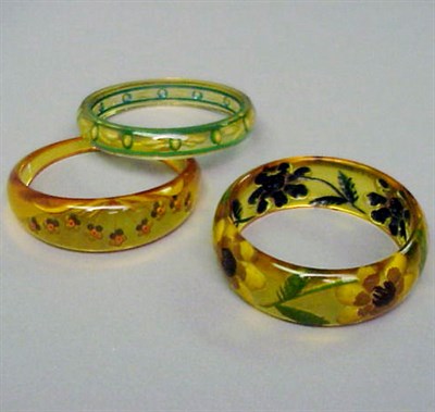 Lot 550 - Group of Three Bakelite Reverse Carved and...